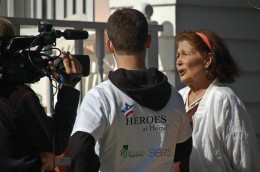 ROTC Joe Ferlito holds the microphone for a Channel 7 interview with homeowner Anna Solomon during Rebuilding Together Oakland County’s 2013 Rebuild Day. Photo provided by Linda Rogers.